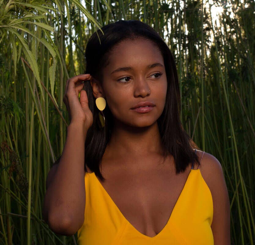 Woman of color in a rainforest as a symbol of Daye's sustainable and inclusive vision of healthcare