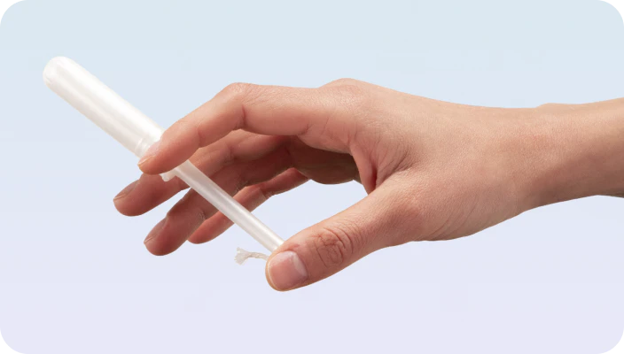 A hand holding a Daye diagnostic tampon