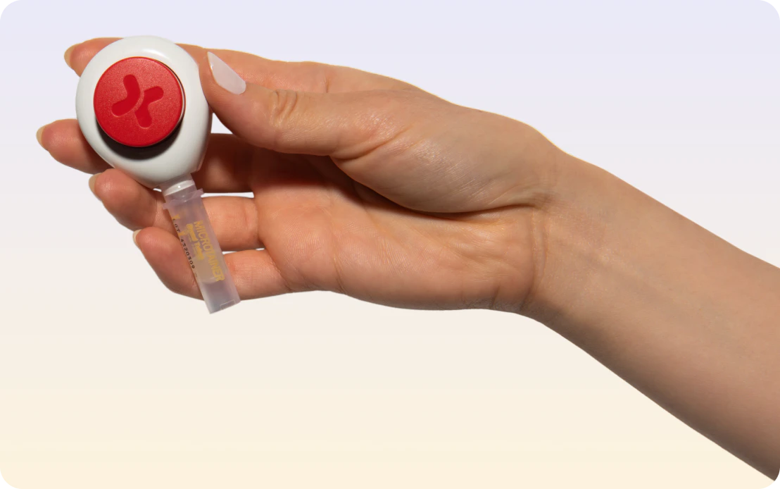 A hand holding the Daye needle-free hormone test device