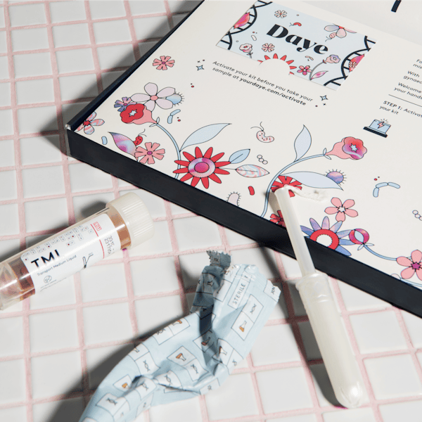 Box of Daye's at-home STI screen kit with an open tampon wrapper.