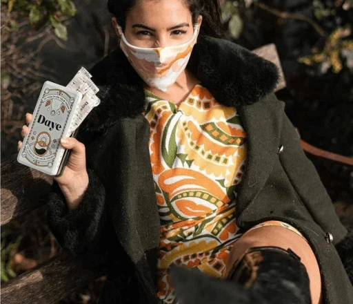 Woman holds recyclable aluminium tin filled with four organic, eco-friendly, natural, cotton fibre Daye tampons