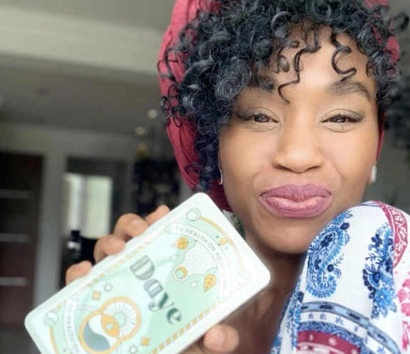 Female taking a selfie with beautiful organic CBD tampon gift box