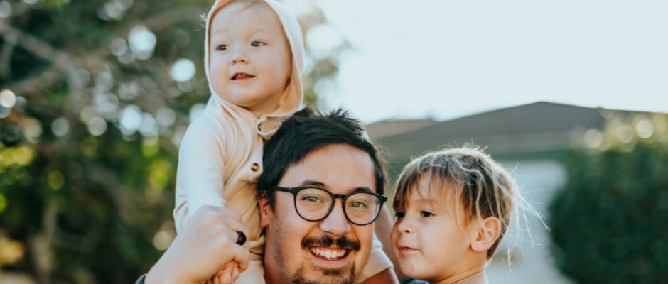 Father holding his two children