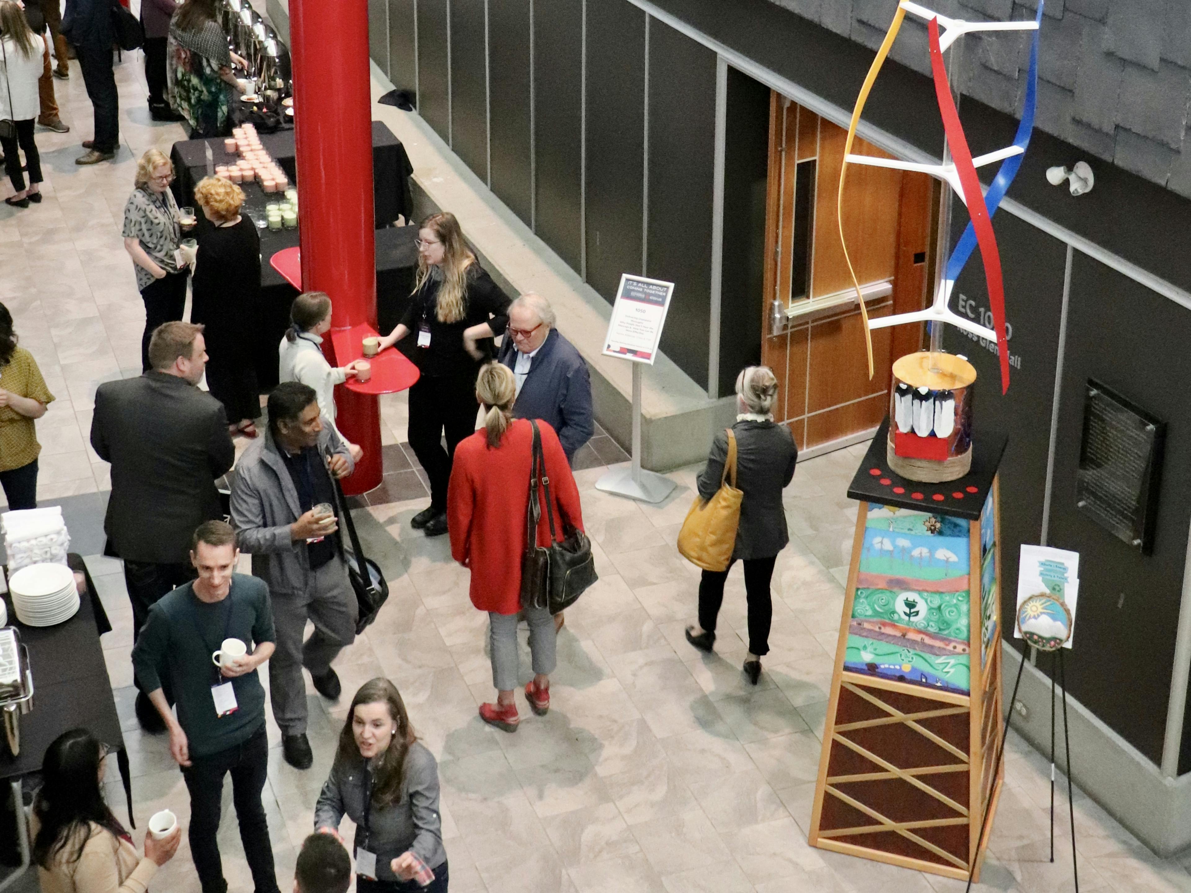 event foyer with guests and art displays