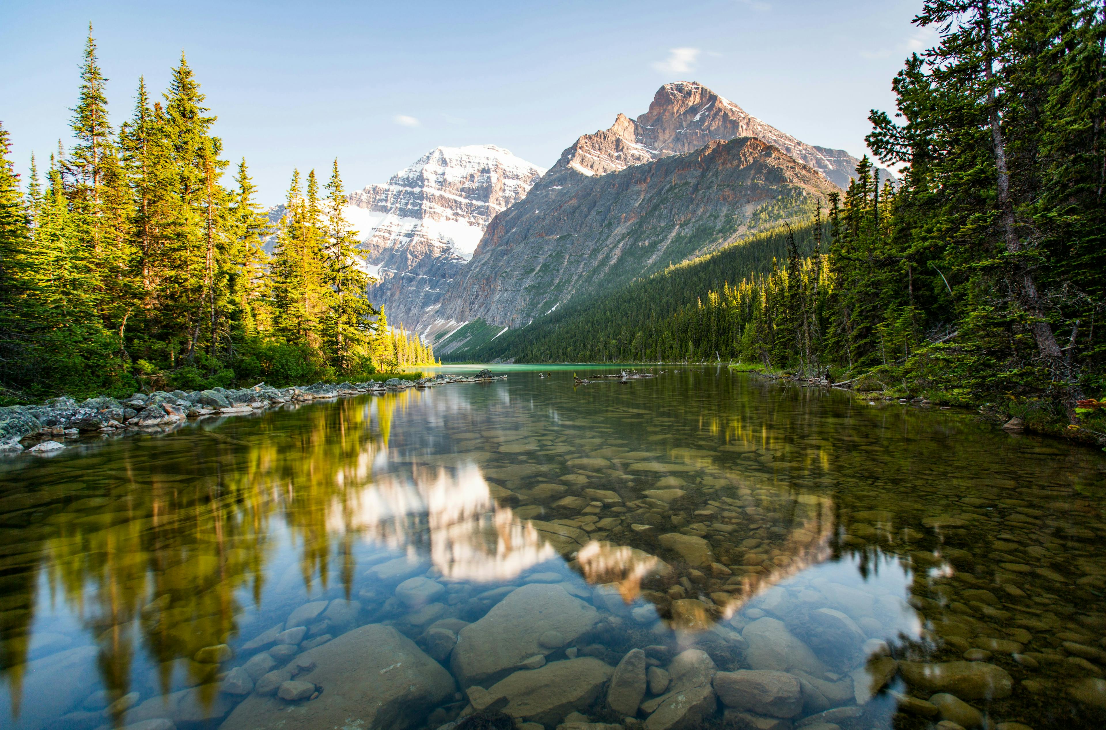 Calm lake in front of mountain and yellow trees