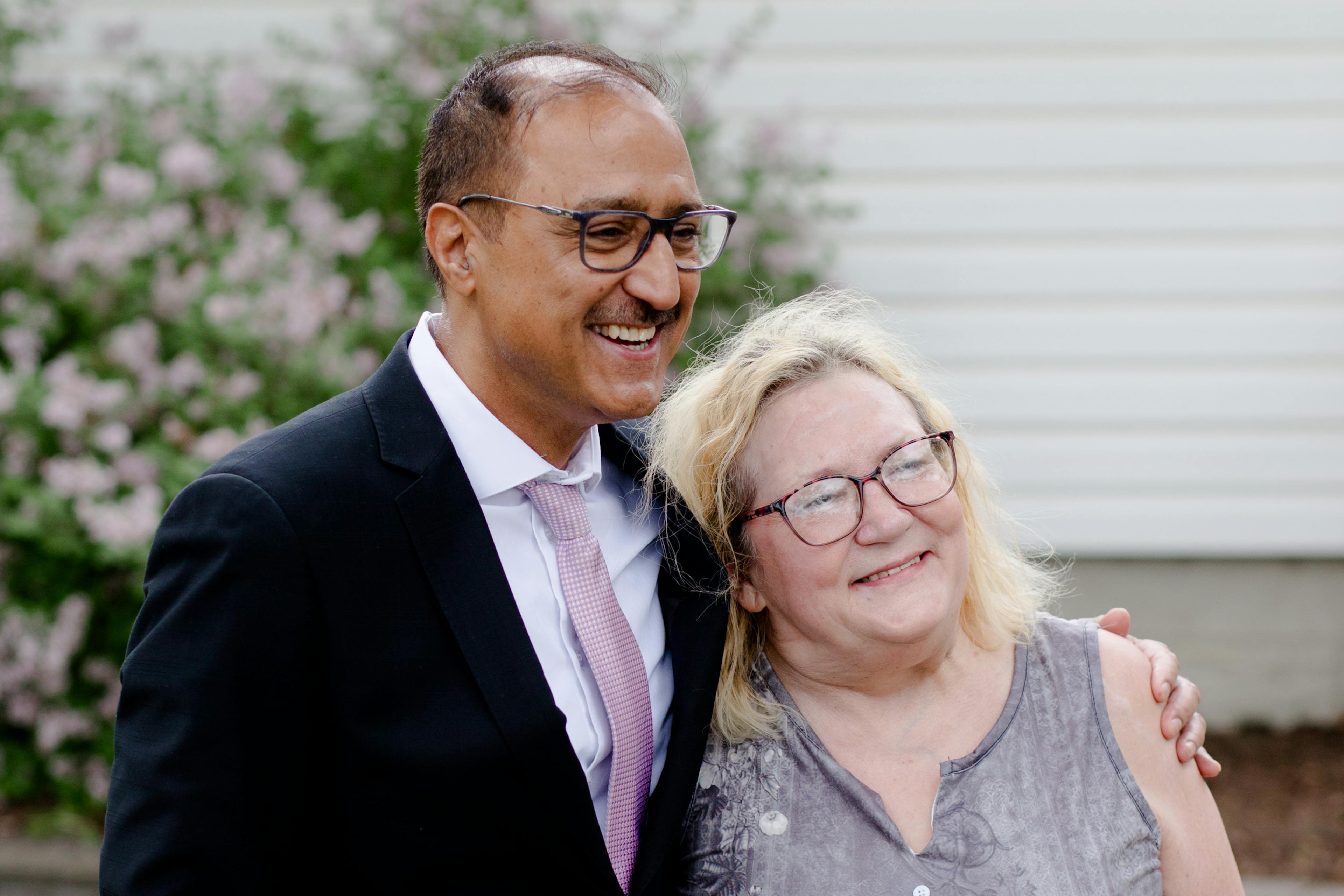 woman and man stand shoulder to shoulder