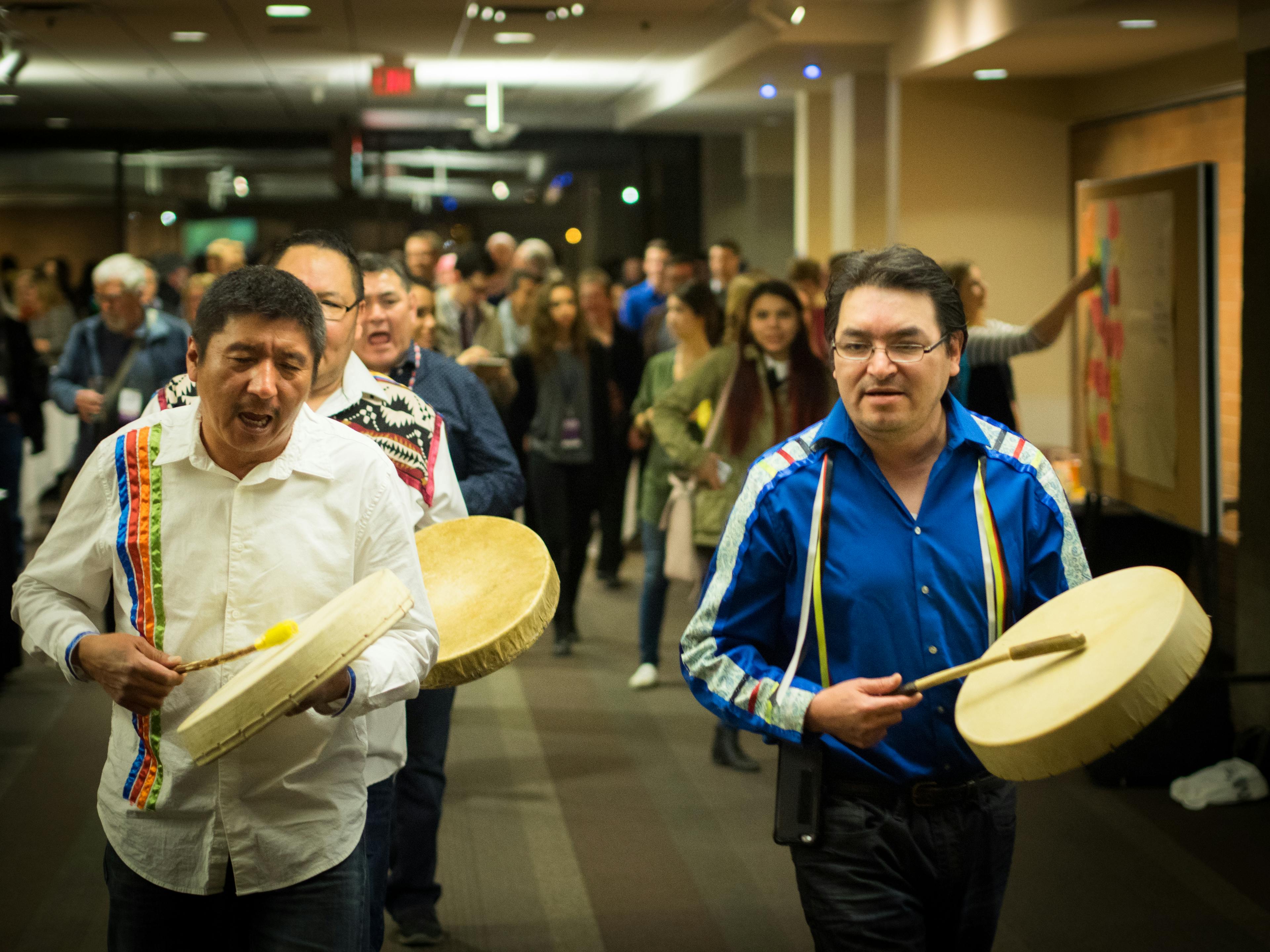 Men drumming on handheld drums