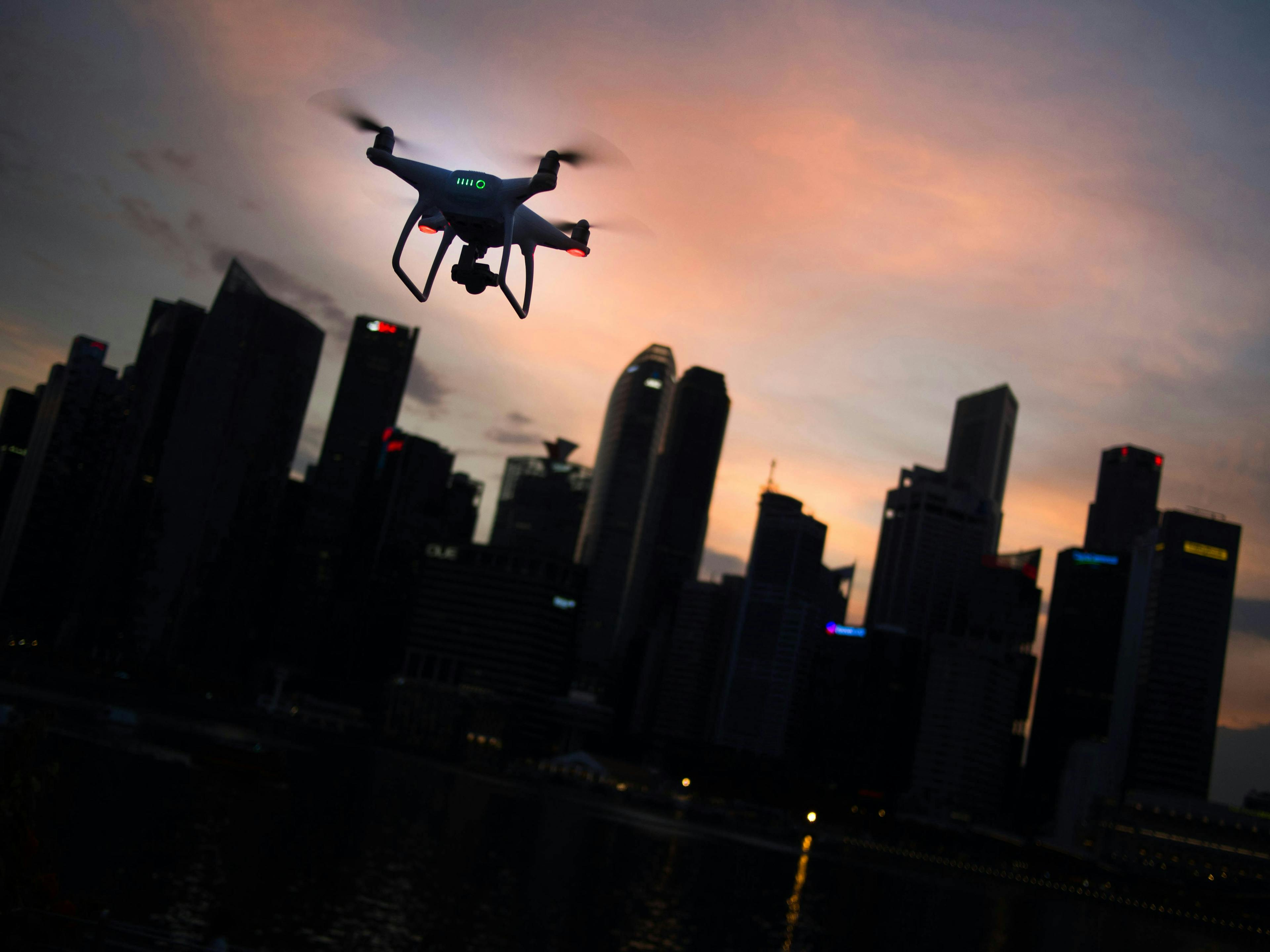 drone flying in front of downtown buildings