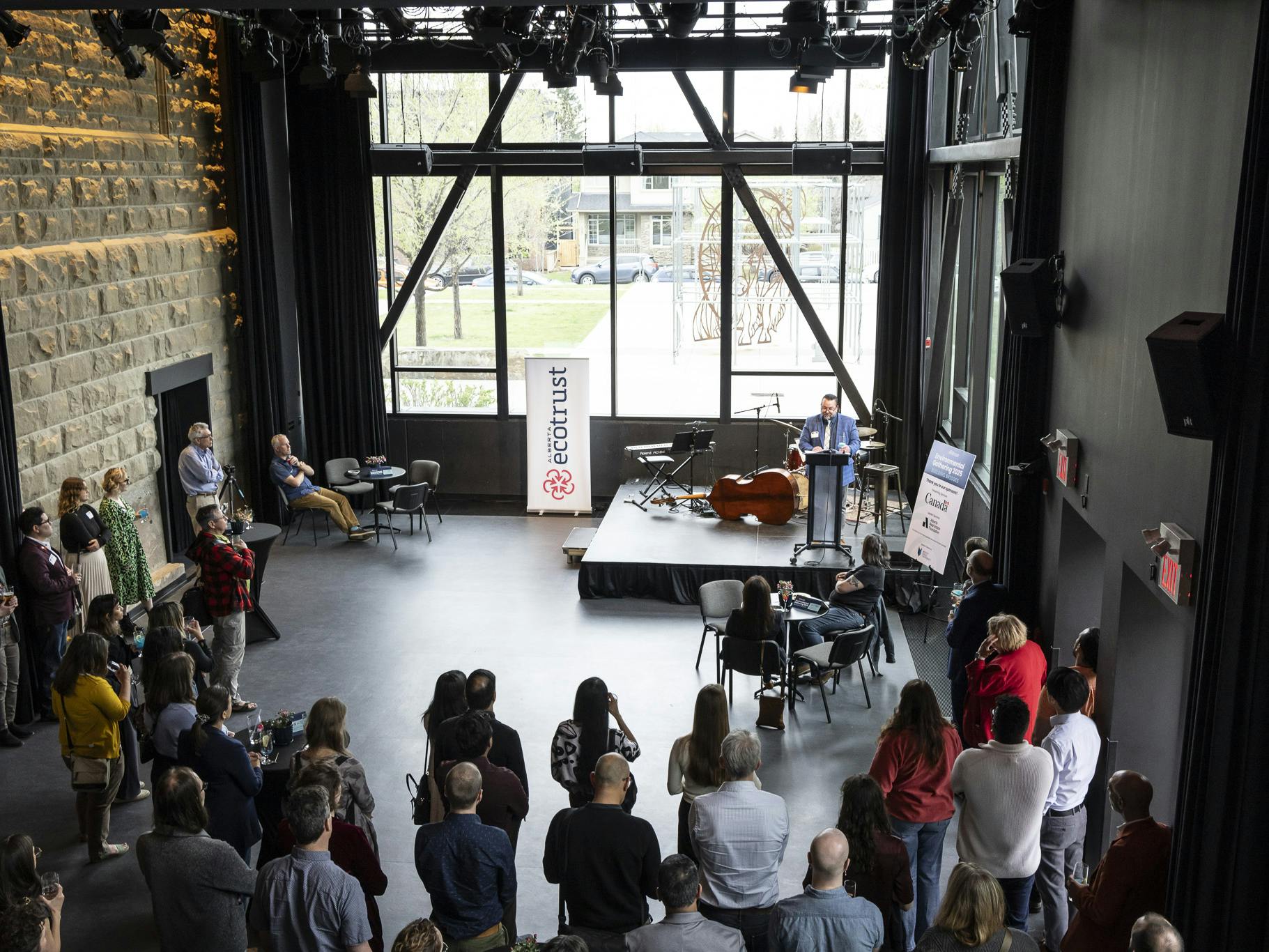 people in event hall watching speaker on stage