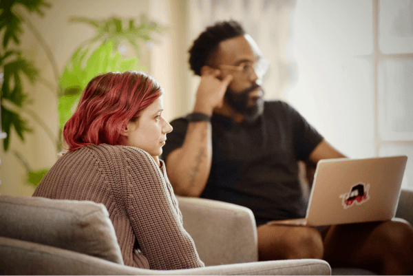 two people listening attentively to a speaker not in frame