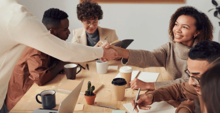 Intentional inclusion, leader shaking hands of team