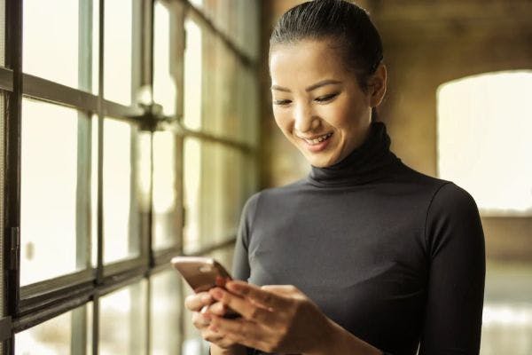 A woman engaged in elearning on their mobile device