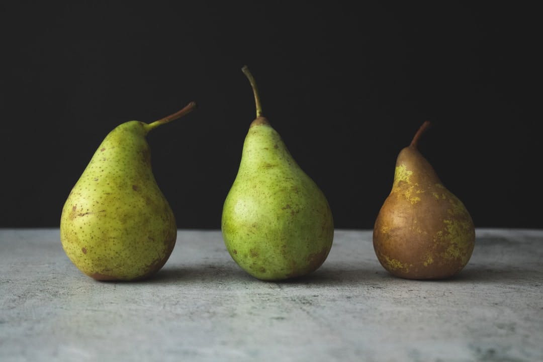 Three pears on dark background