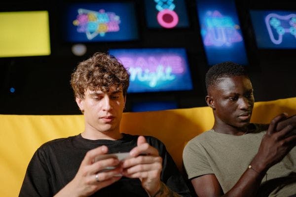 Two people playing games on their mobile phones