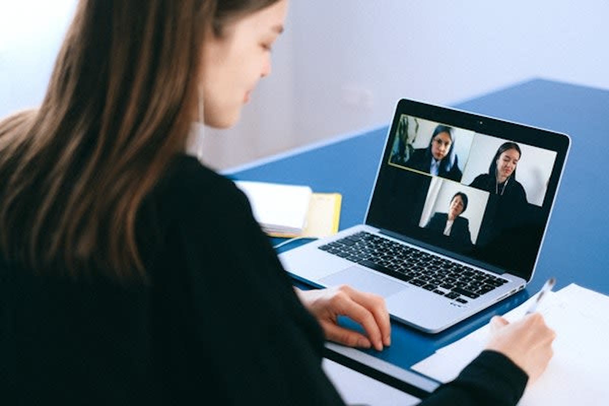 Woman infront of her laptop on a Zoom call