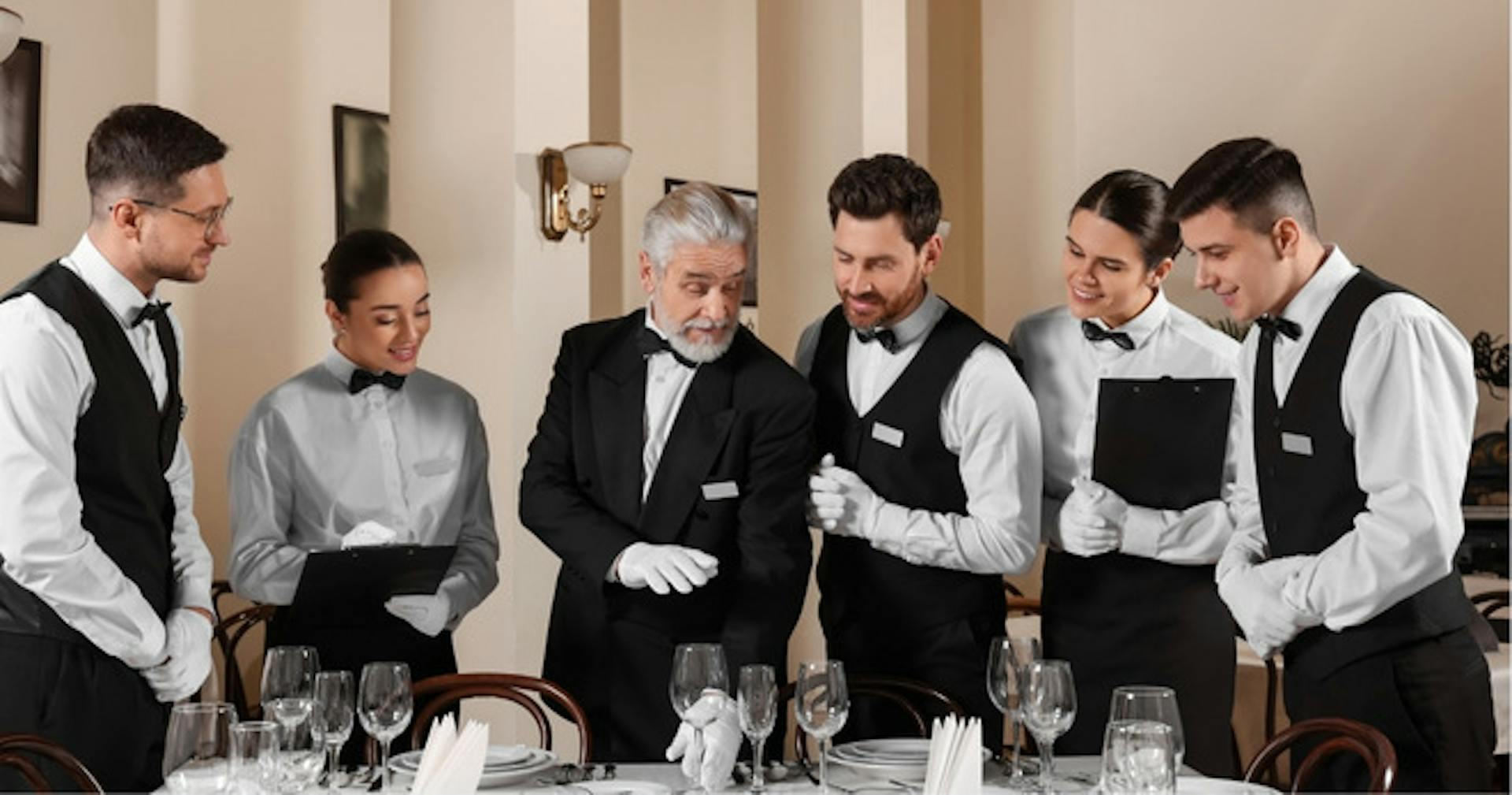 Senior hotel staff offering mentorship and apprenticeship to new hires.