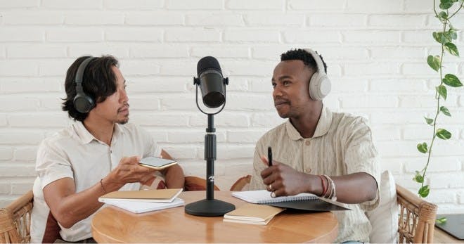 Two people hosting a podcast.