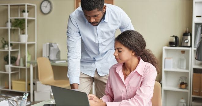 A manager mentoring another employee