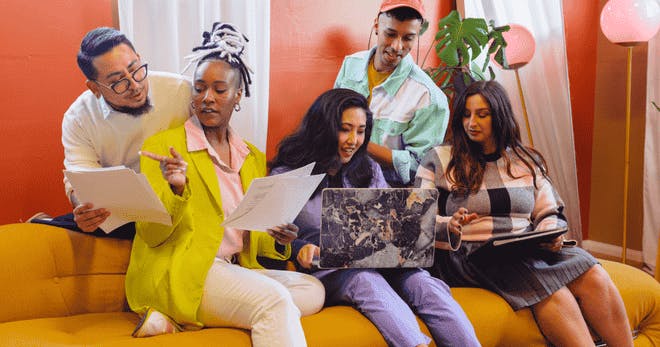 Employees having fun on the couch and discussing ideas together