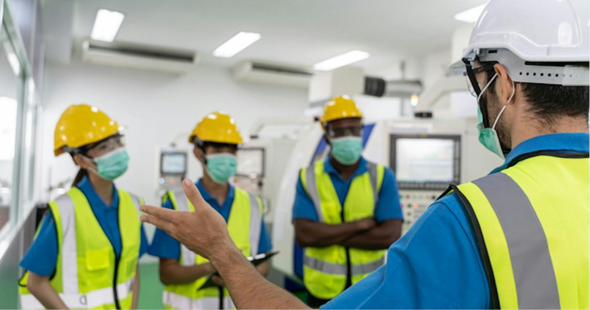 A senior production worker instructing his crew