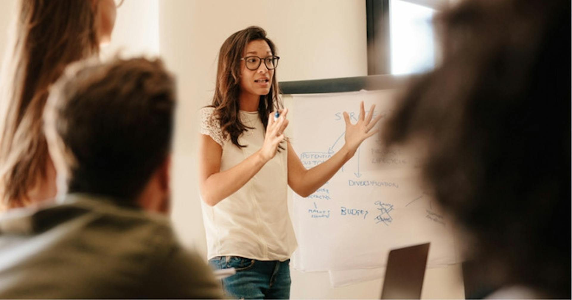 A woman presenting her expert knowledge in front of a crowd