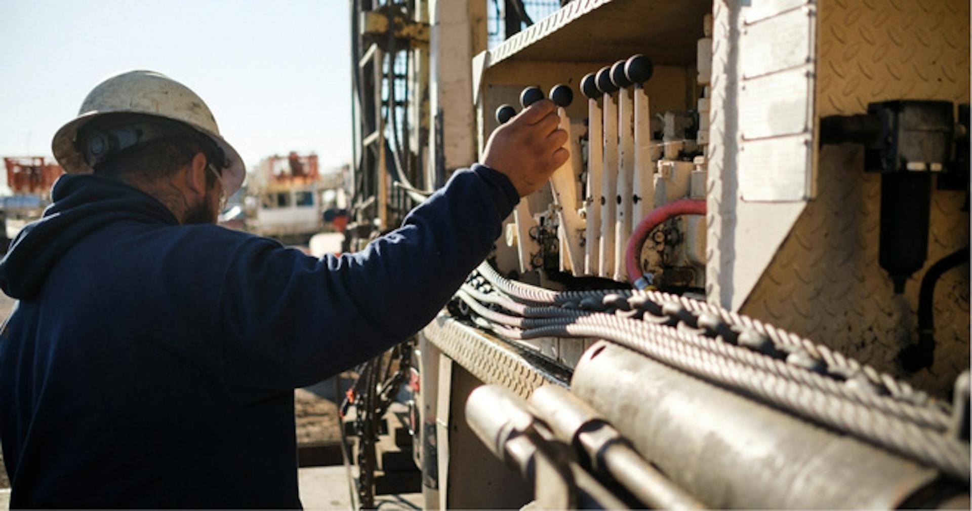 A man operating a machine outside