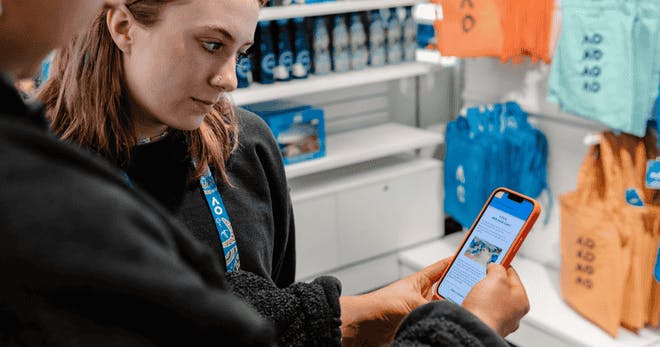 Store employees taking an online course on a mobile phone