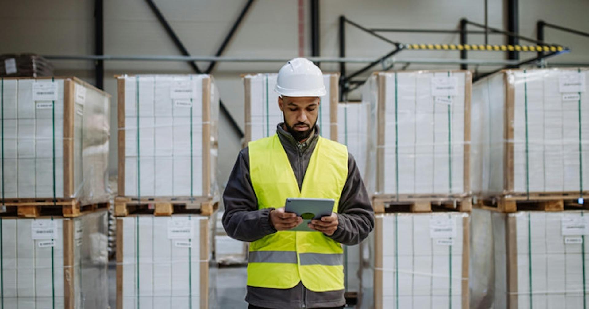 A logistics manager reading about frontline leadership training on a tablet