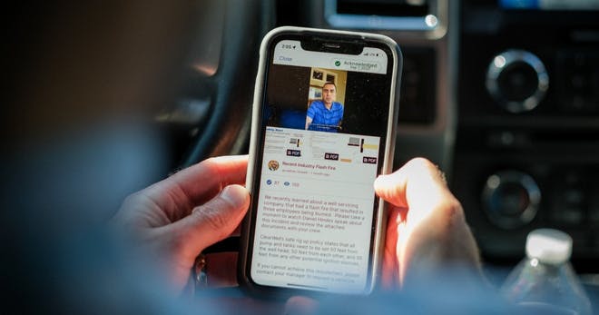 An employee reading on the latest fire safety statistics on his phone