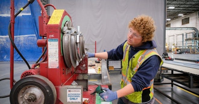 An employee operating an equipment in the warehouse