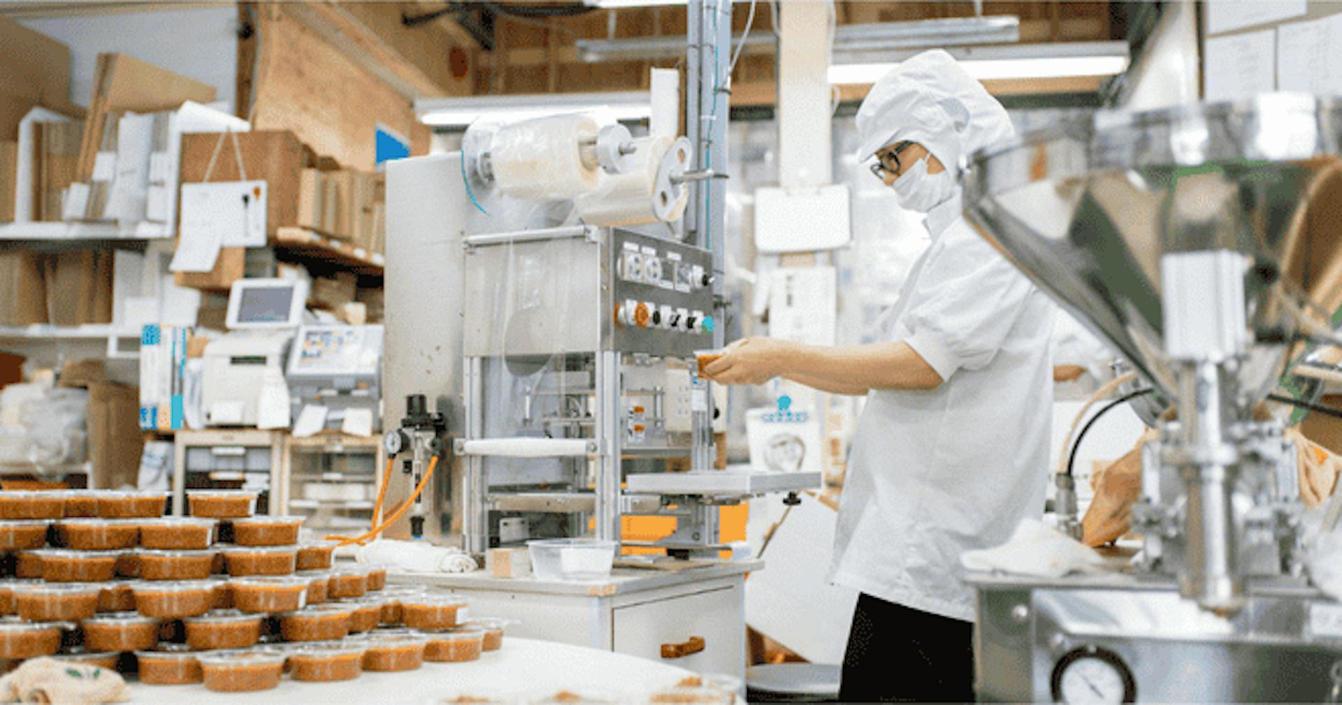 Factory worker packaging food