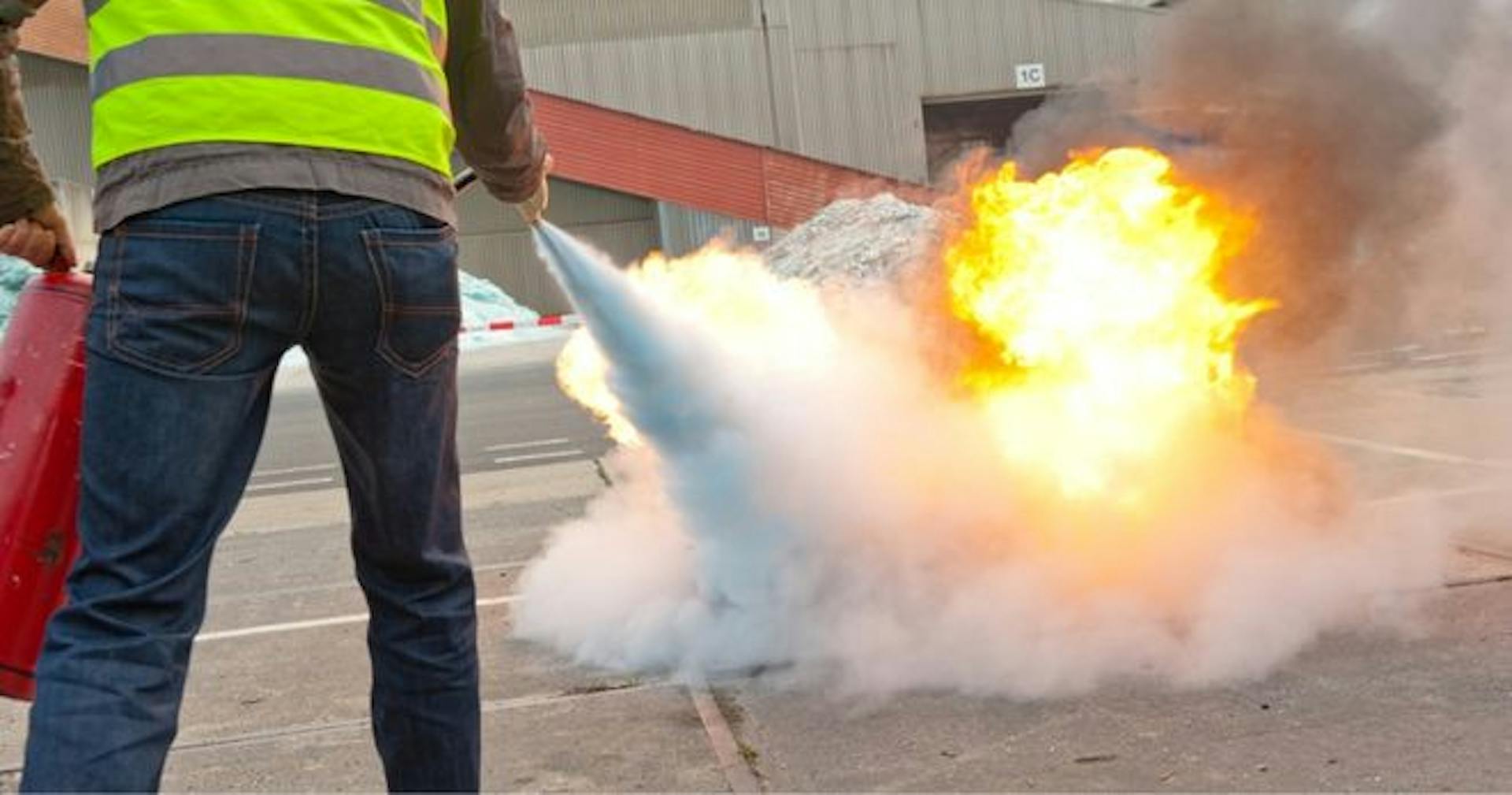 person using a fire extinguisher with the pass method