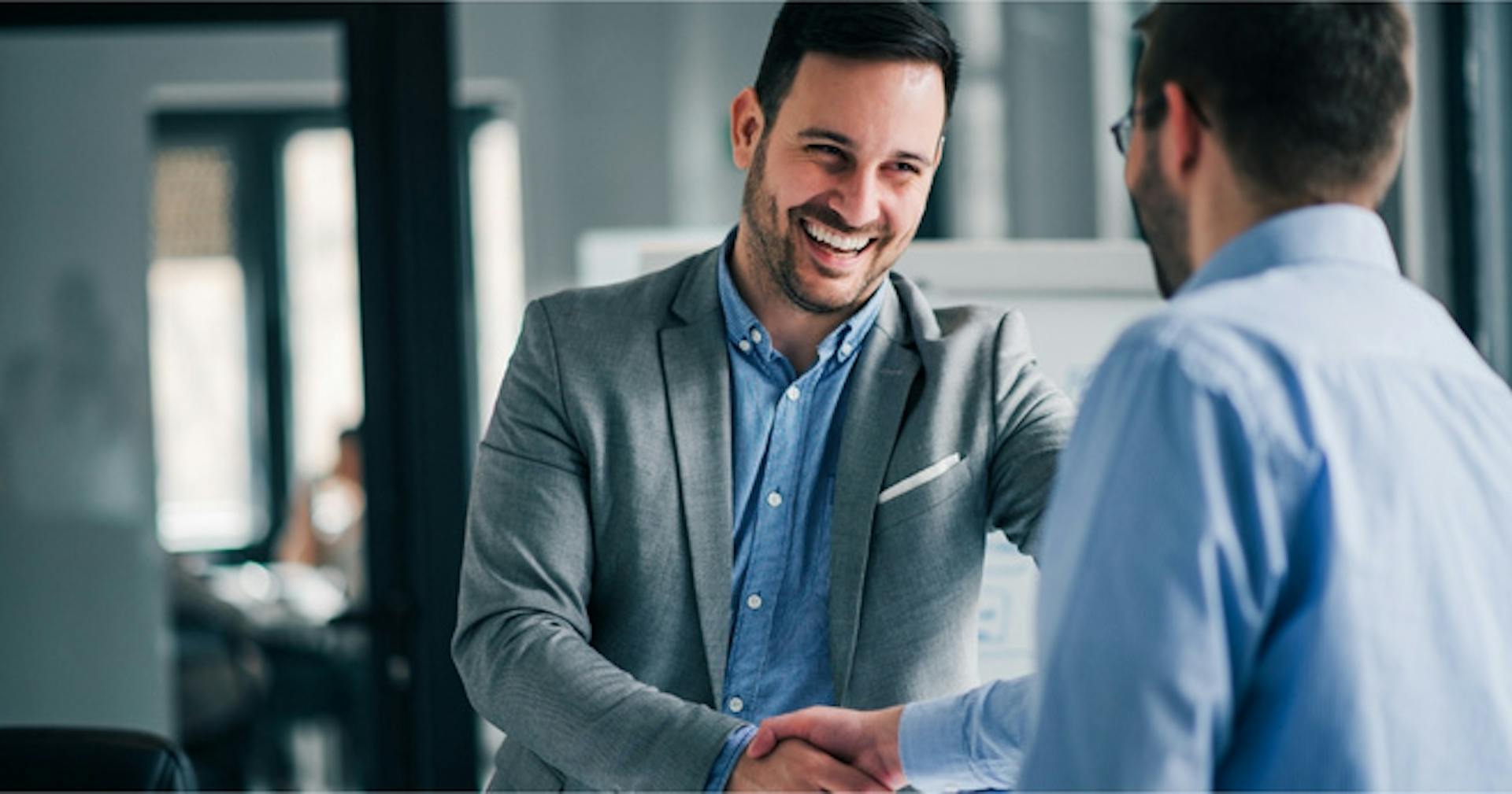 Two employees shaking hands