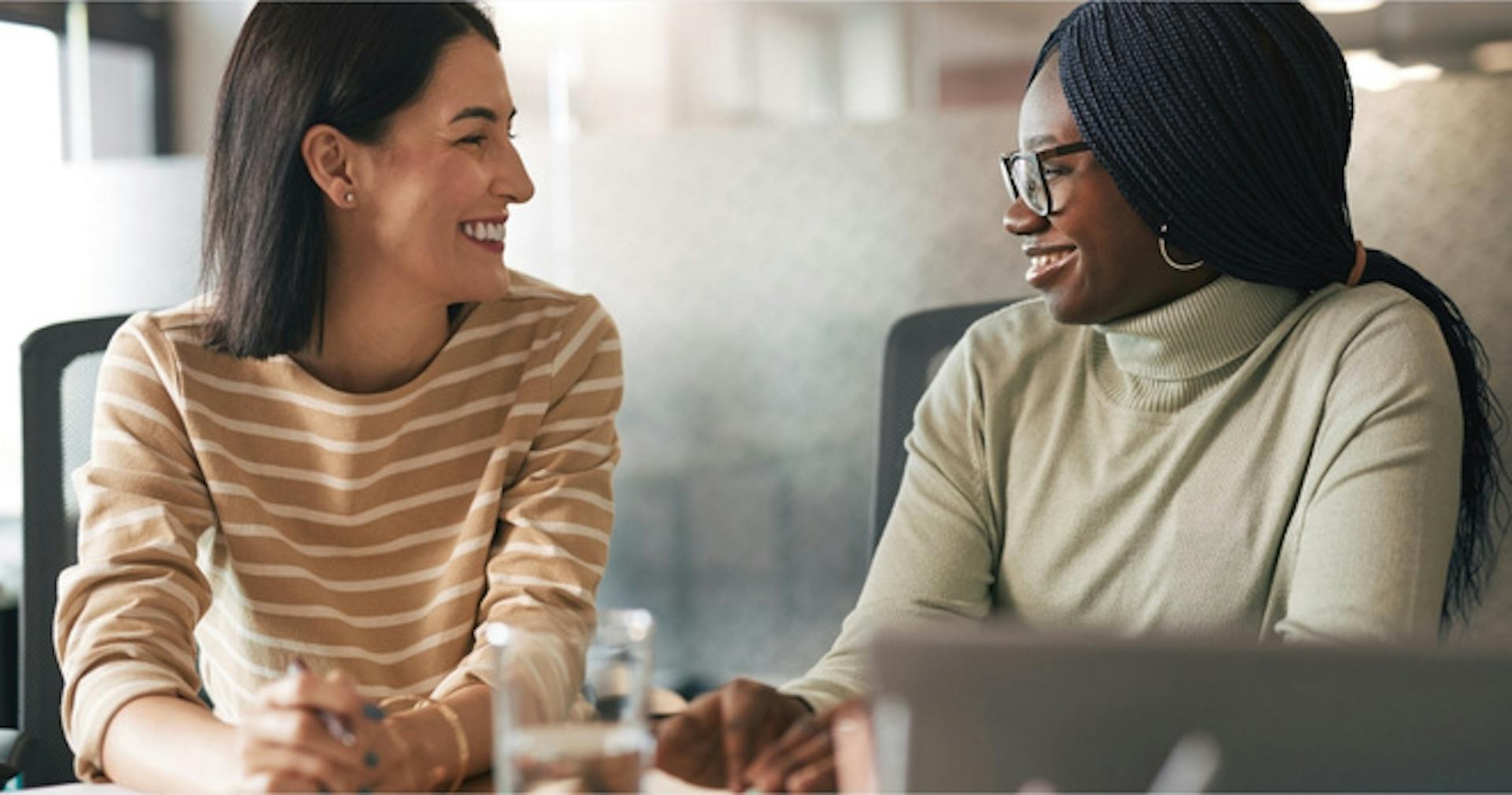 Employees discussing each other's work 