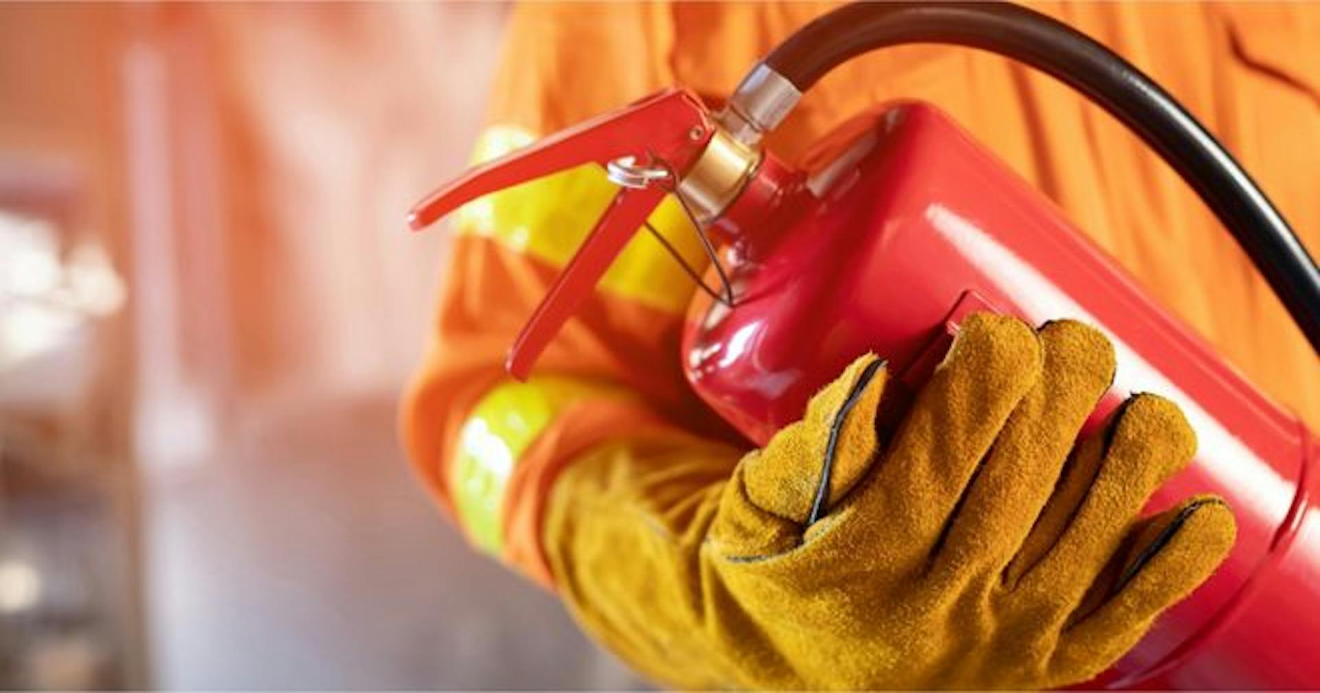 employee carrying a fire extinguisher