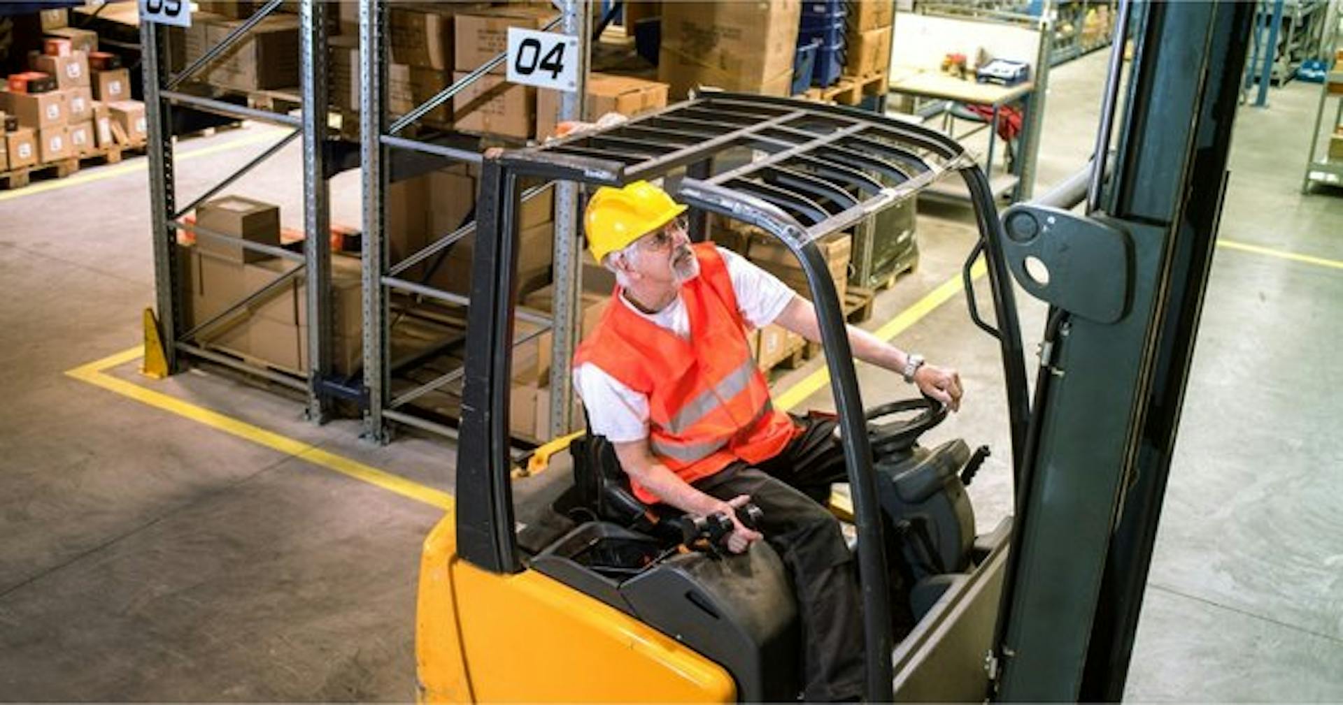 forklift operator carefully lifting pallets