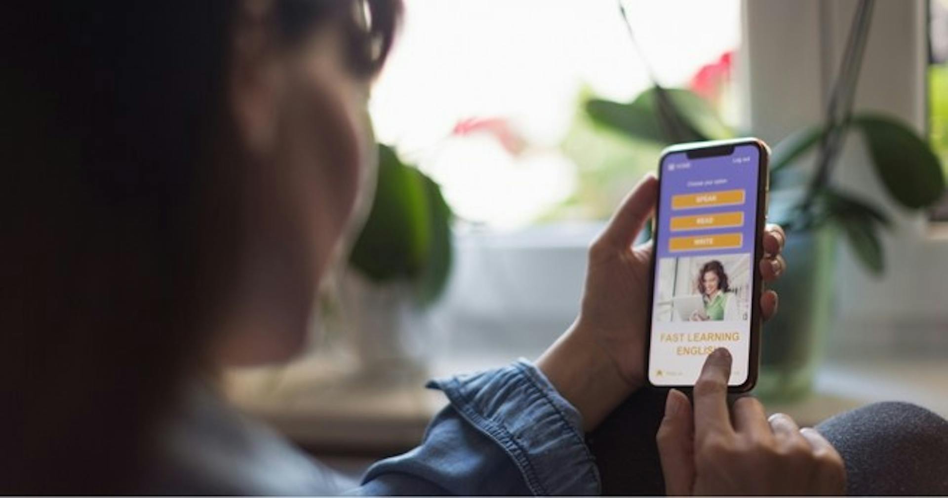 A woman taking an online training course on her phone