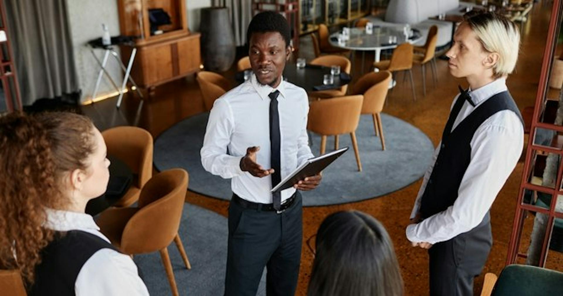 A manager informing his restaurant crew of the importance of food safety