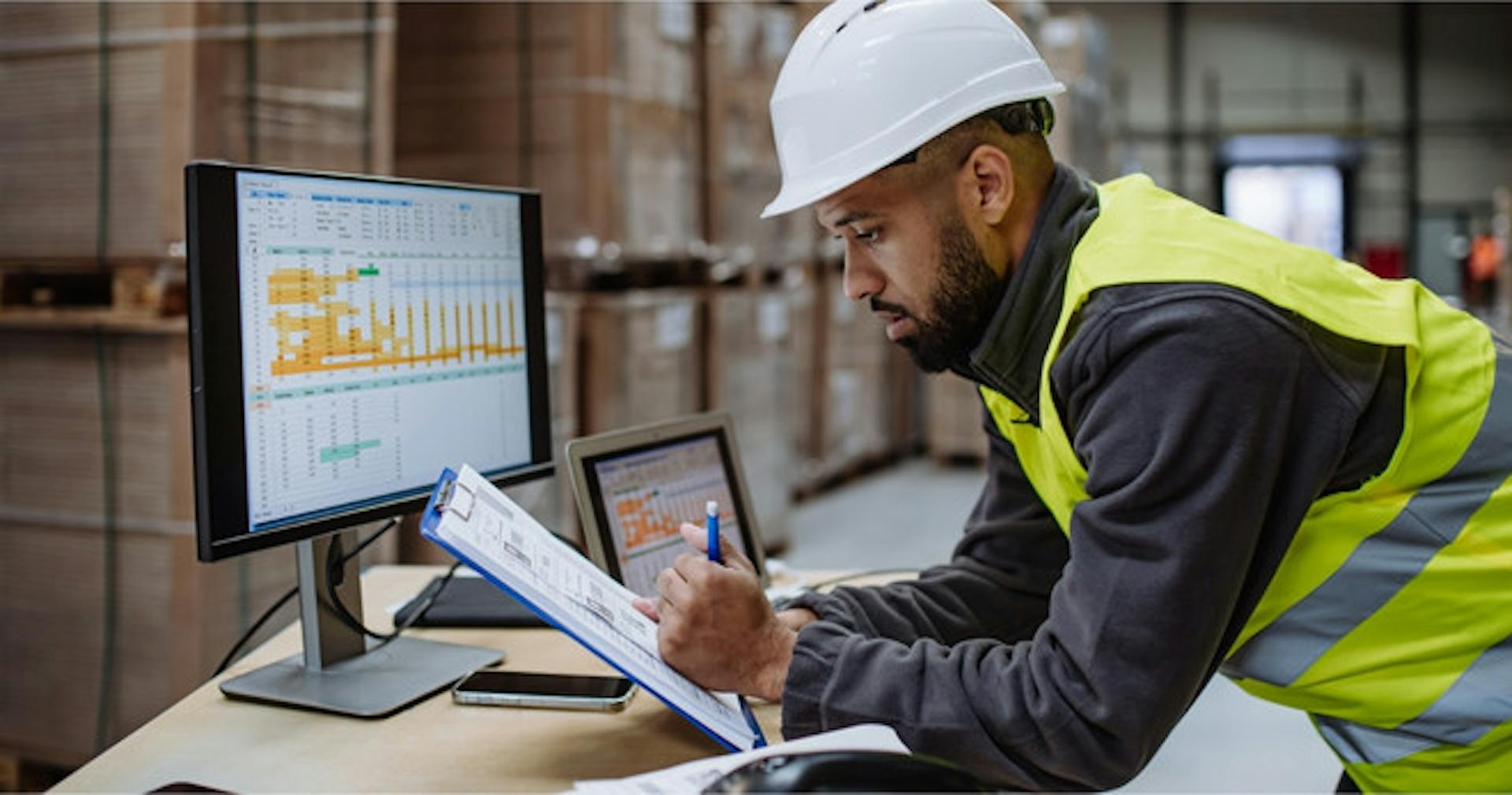 A logistics worker reviewing shipment data