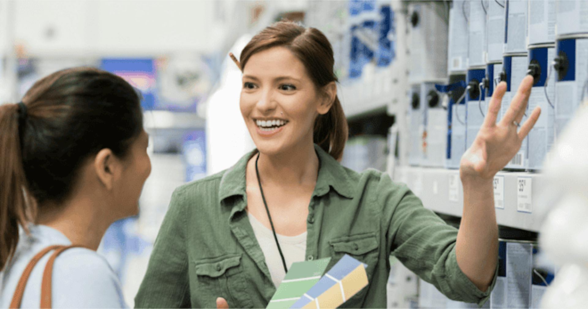 Paint store salesperson helping customer