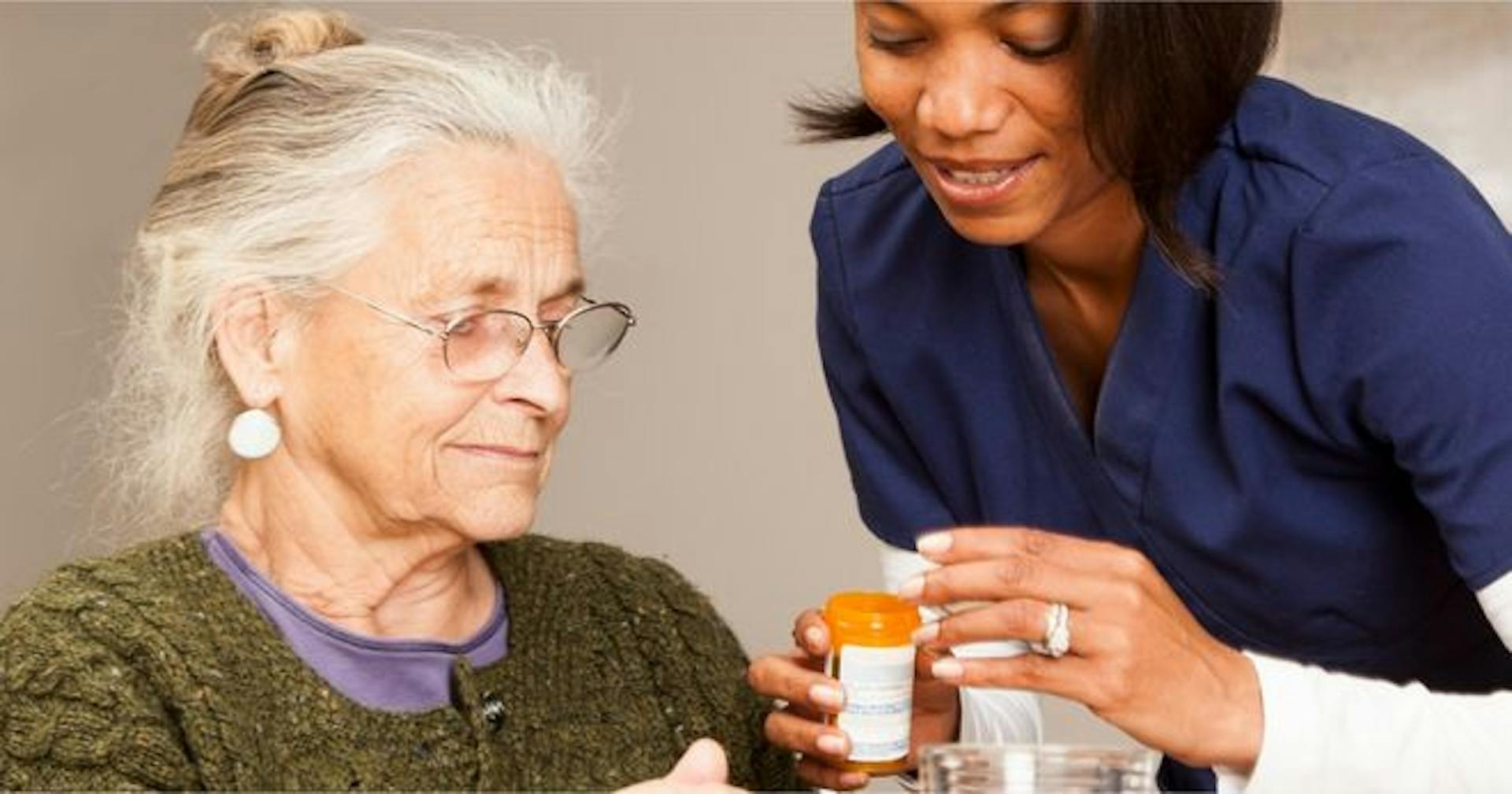 Caregiver giving medicine to patient using her medical knowledge