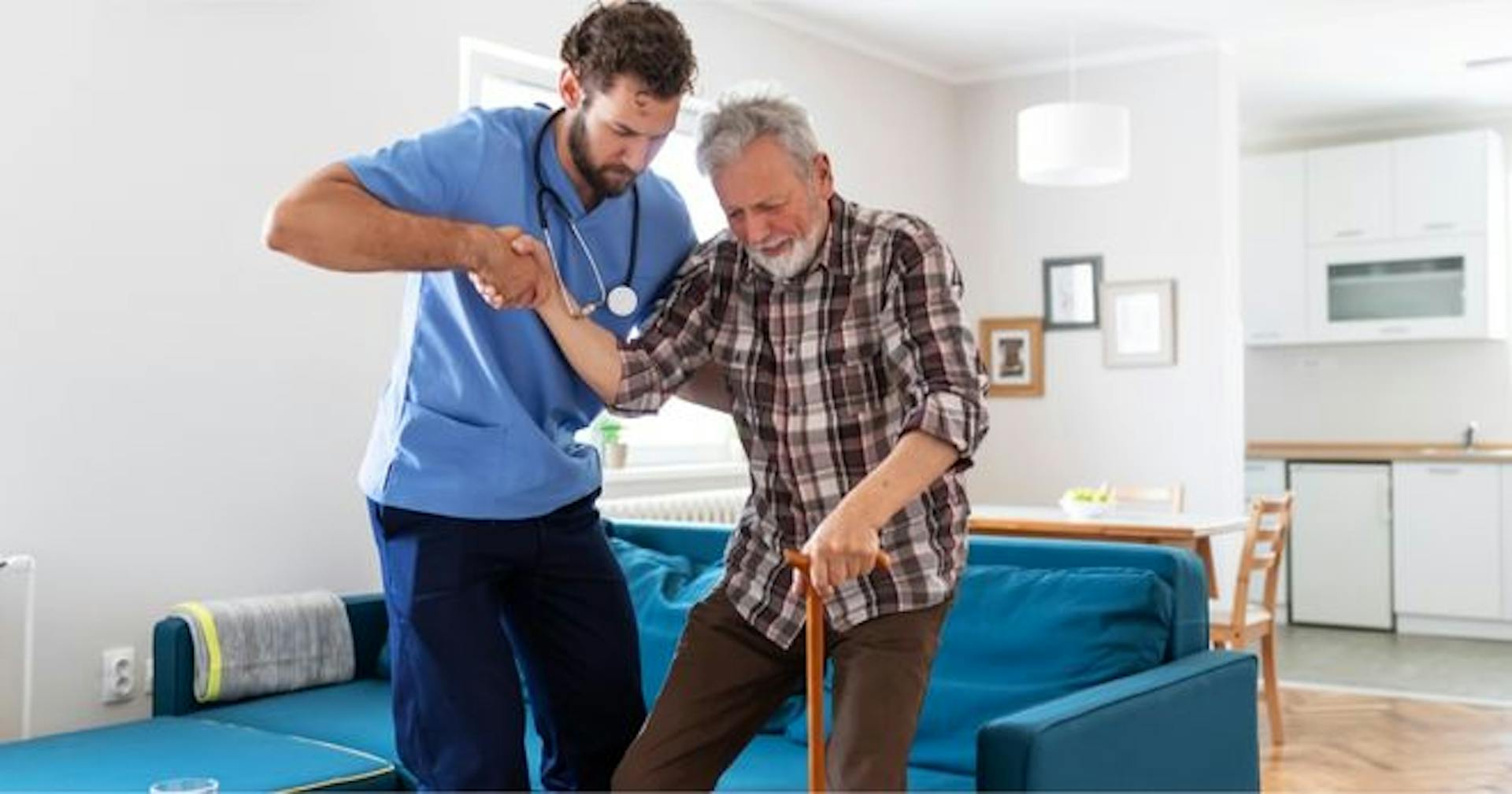 Male caregiver carrying patient and assisting him