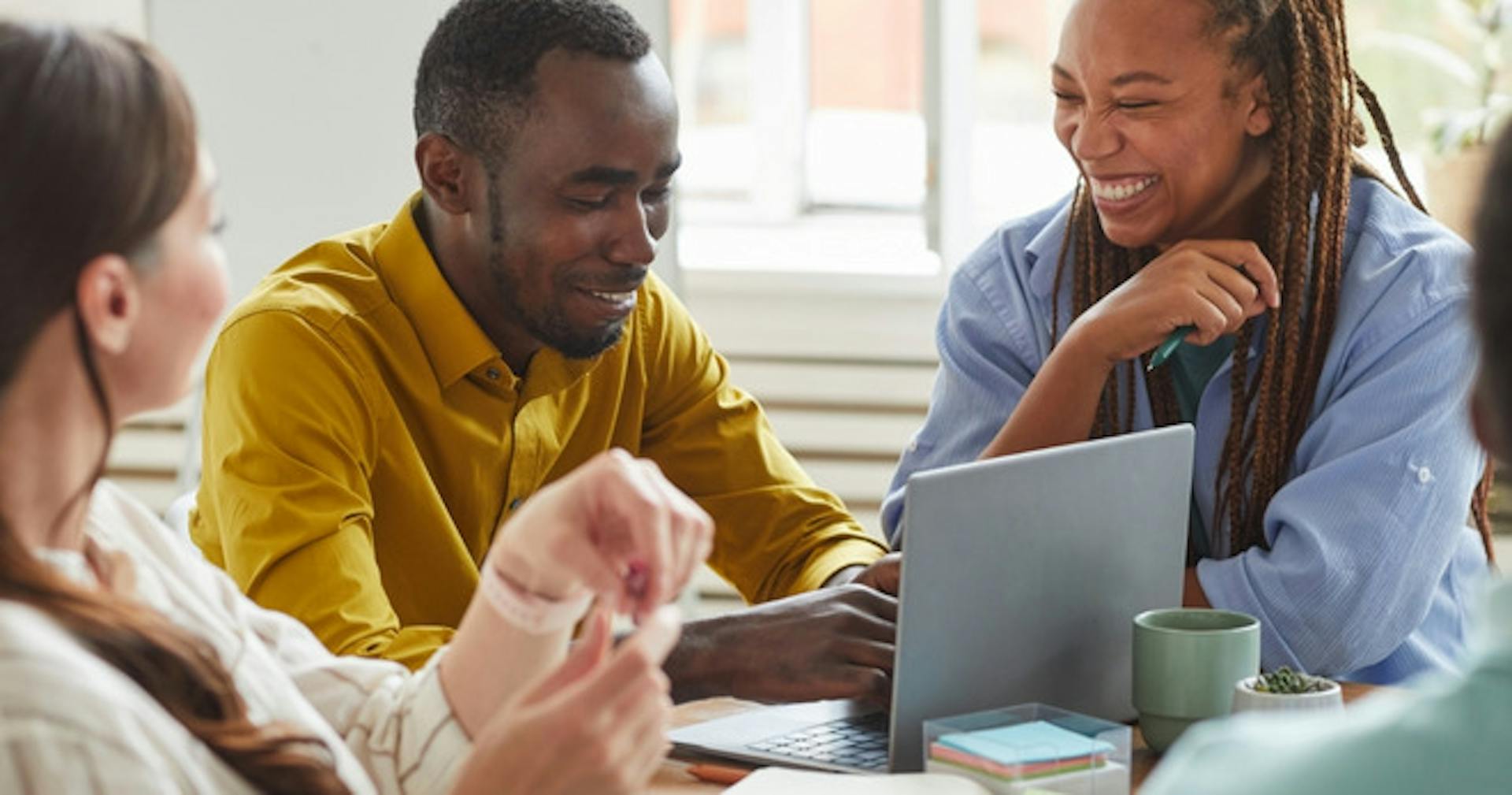 Employees reskilling via an online course on a laptop