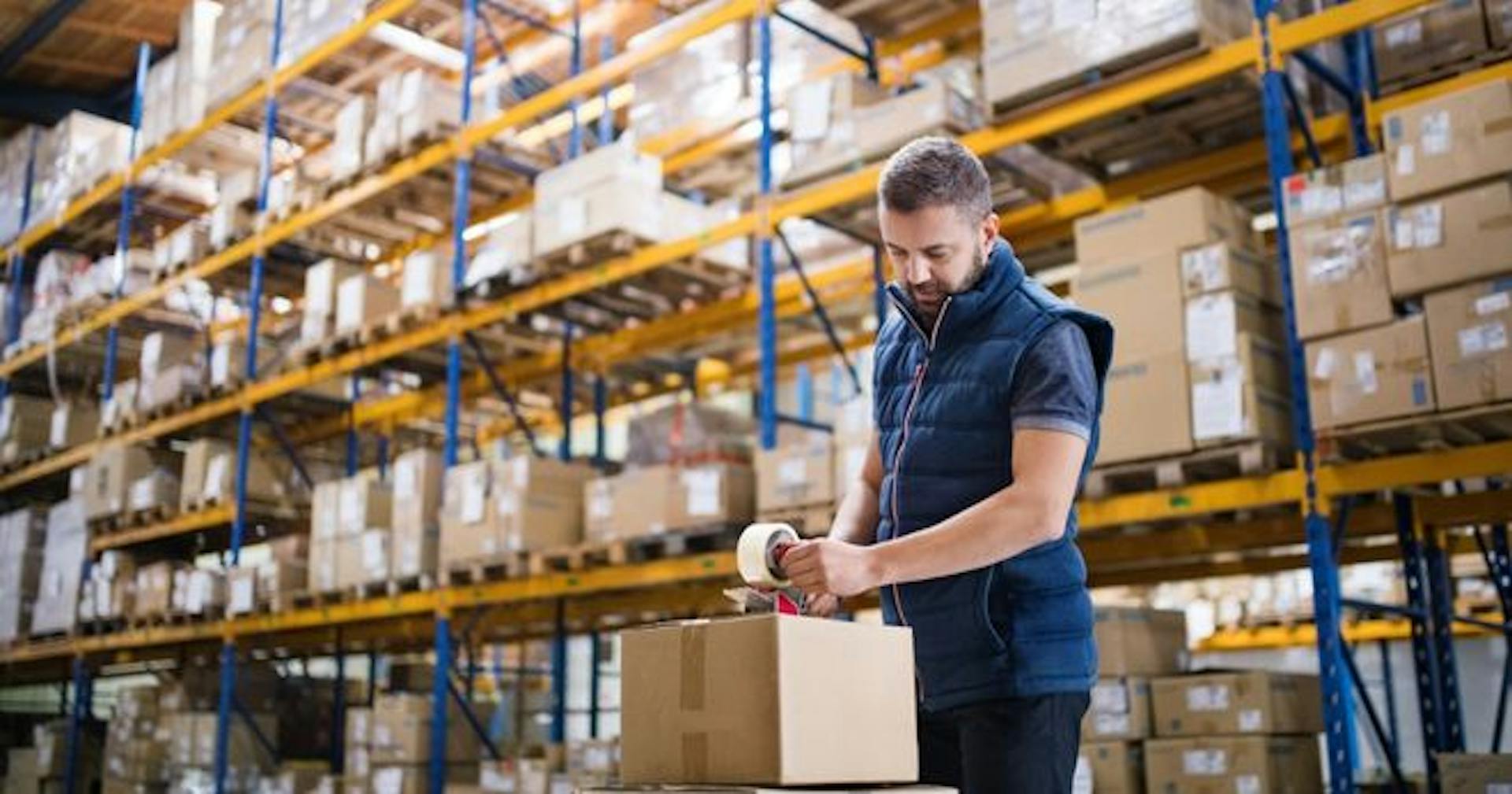 A logistics employee packing a box