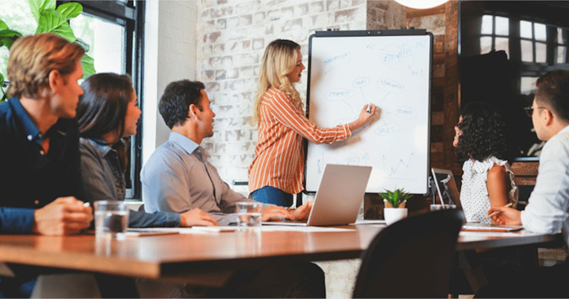 An employee writing on a whiteboard