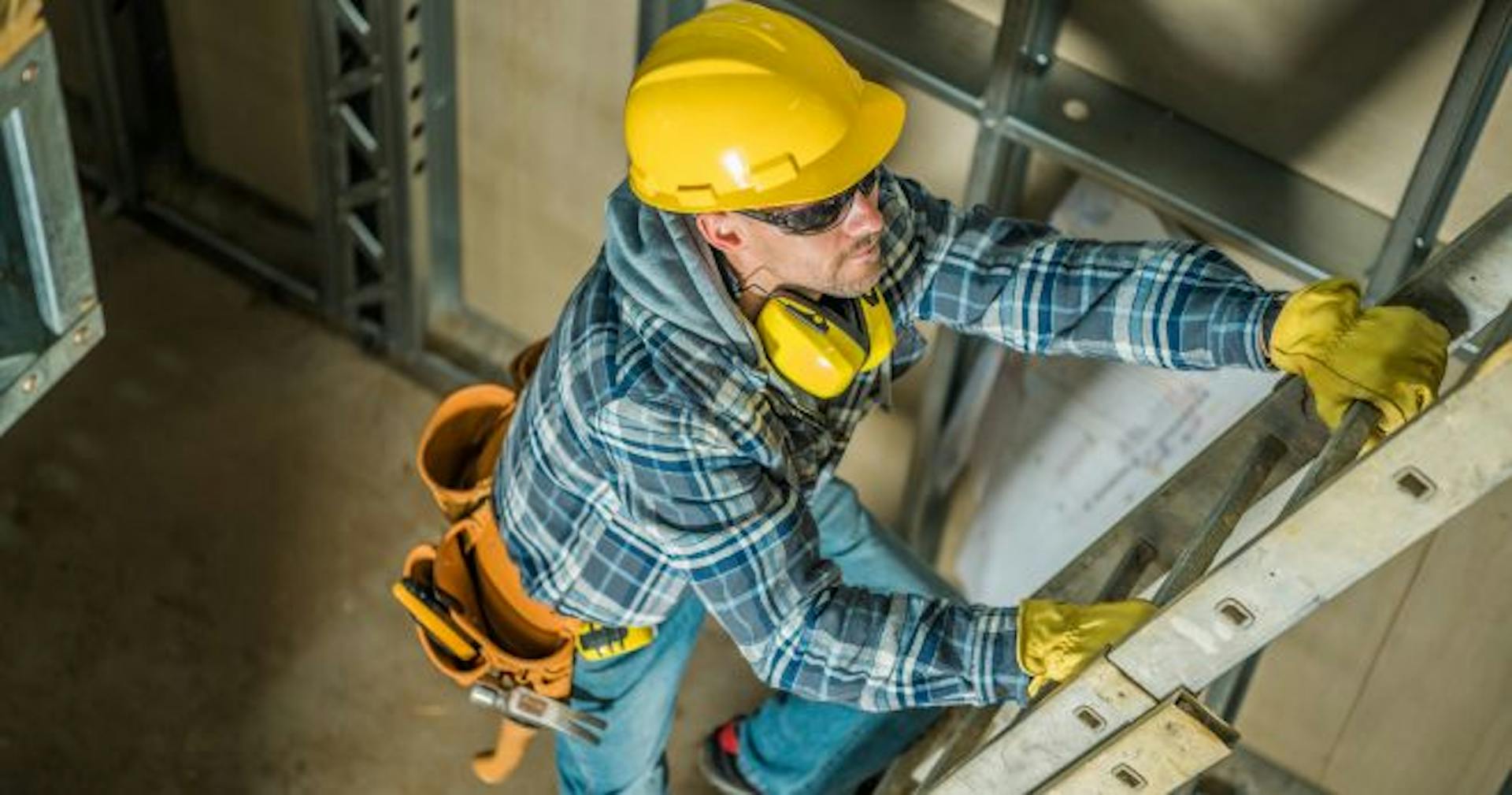 Construction worker climbing the ladder