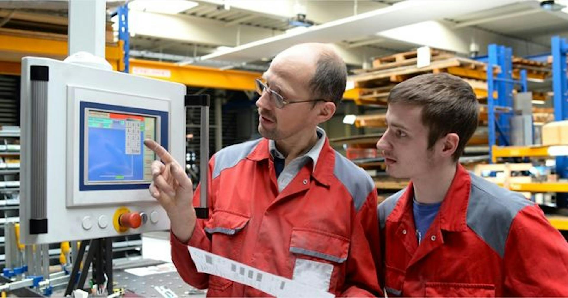 Manager training a manufacturing employee