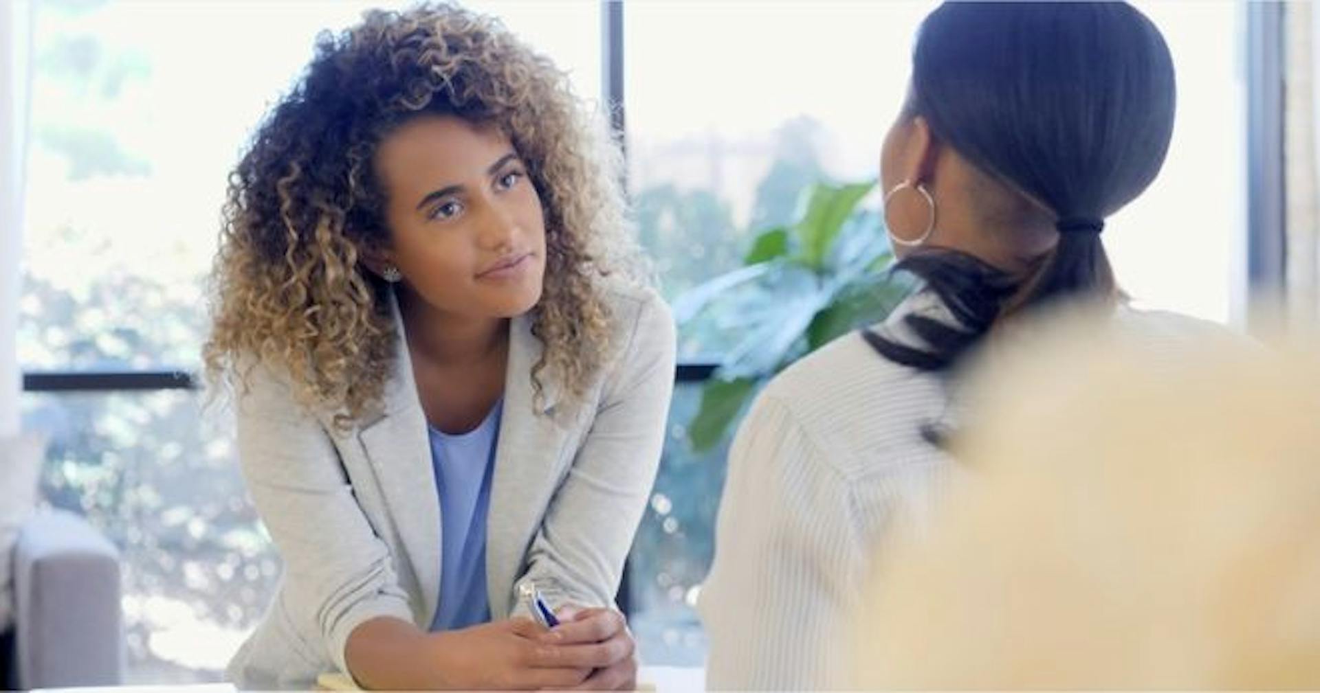 Woman actively listening to her coworker