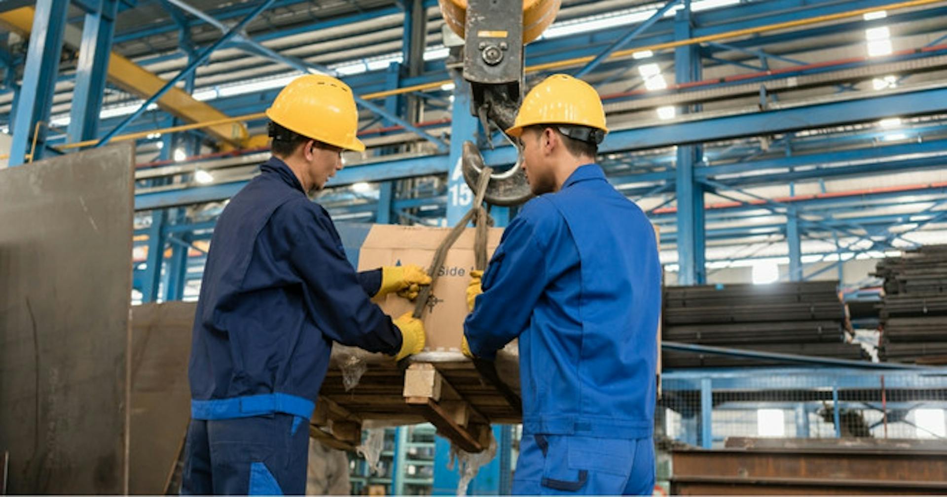 Warehouse workers using crane