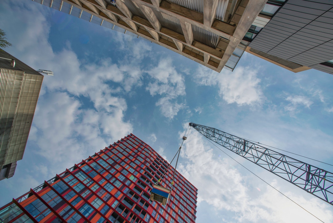 Image of construction site, sky and cranes